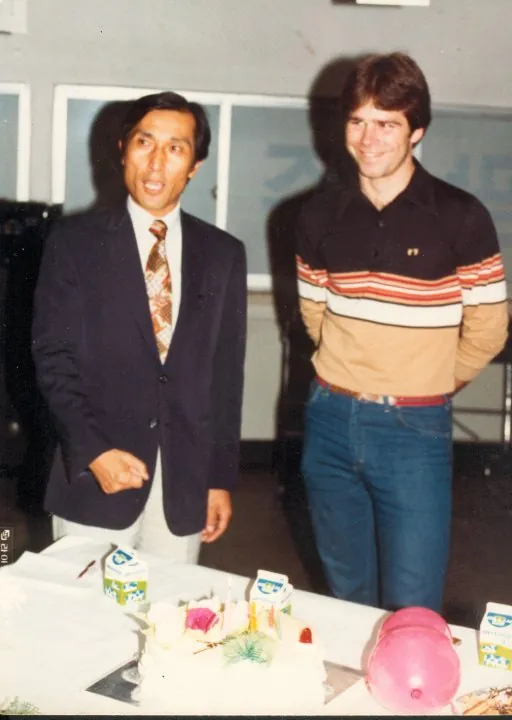 John Song speaking beside Bill at his first birthday in Korea, November 1982