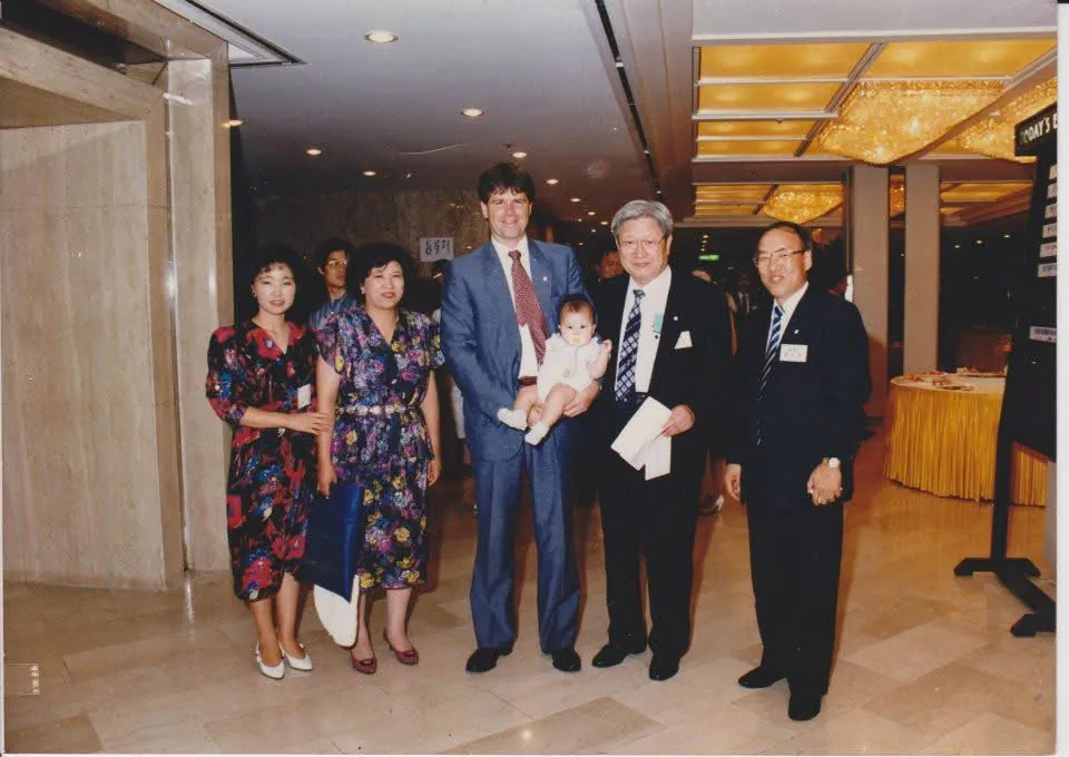 Bill holding infant Sarah at CBMC conference in Japan, summer 1990