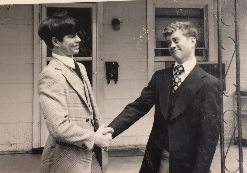 Bill and Steve White, friends since 9th grade, shaking hands