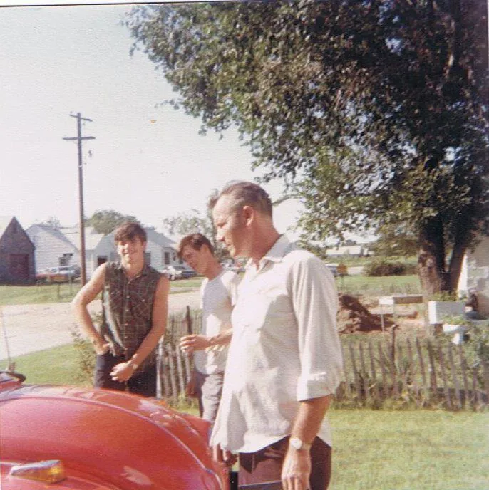 Bill with his father Bud and Uncle Marvin beside the red VW Beetle